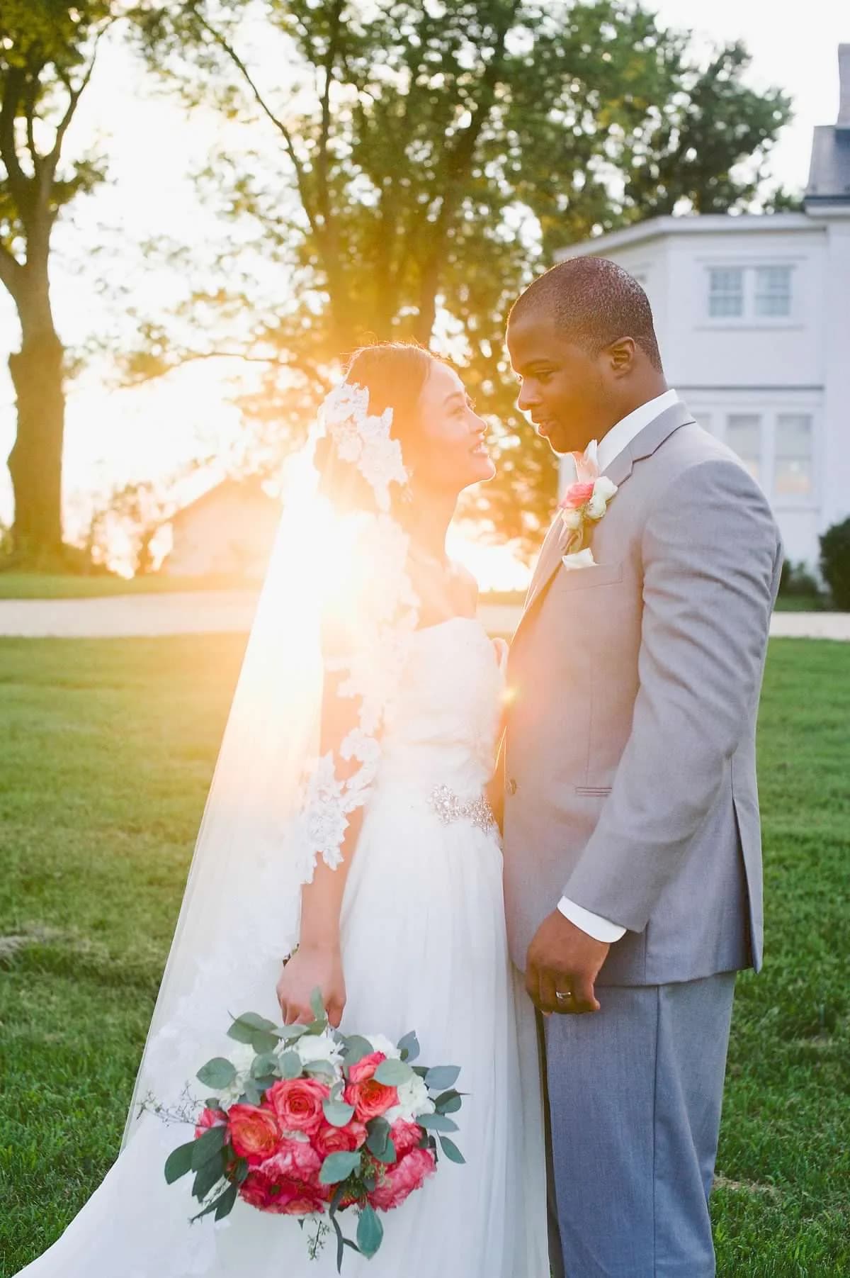 Couple at sunset in front of Rixey Manor, golden light filtering through the trees
