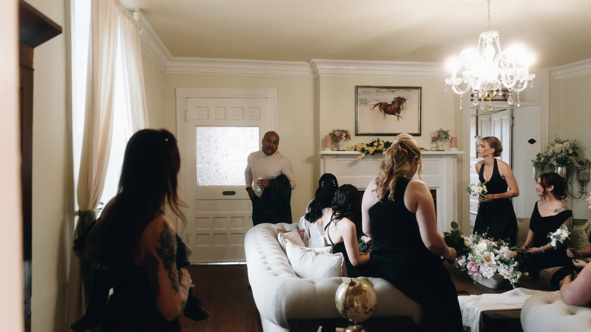 Elegant living room at Rixey Manor with fireplace, leather sofa, and bookshelves
