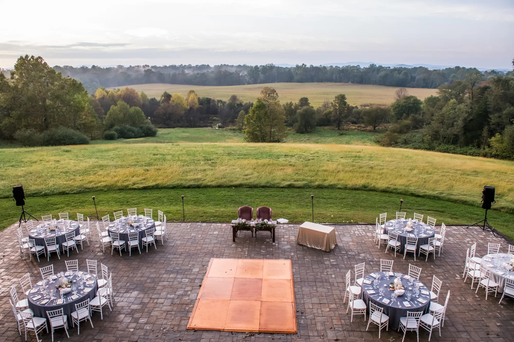 Aerial view of Rixey Manor outdoor reception terrace with dance floor, round tables, and sweeping Virginia countryside views
