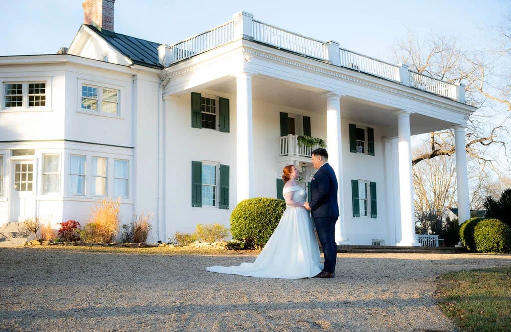 Bride and groom share a quiet moment on the gravel drive before Rixey Manor's white columned facade