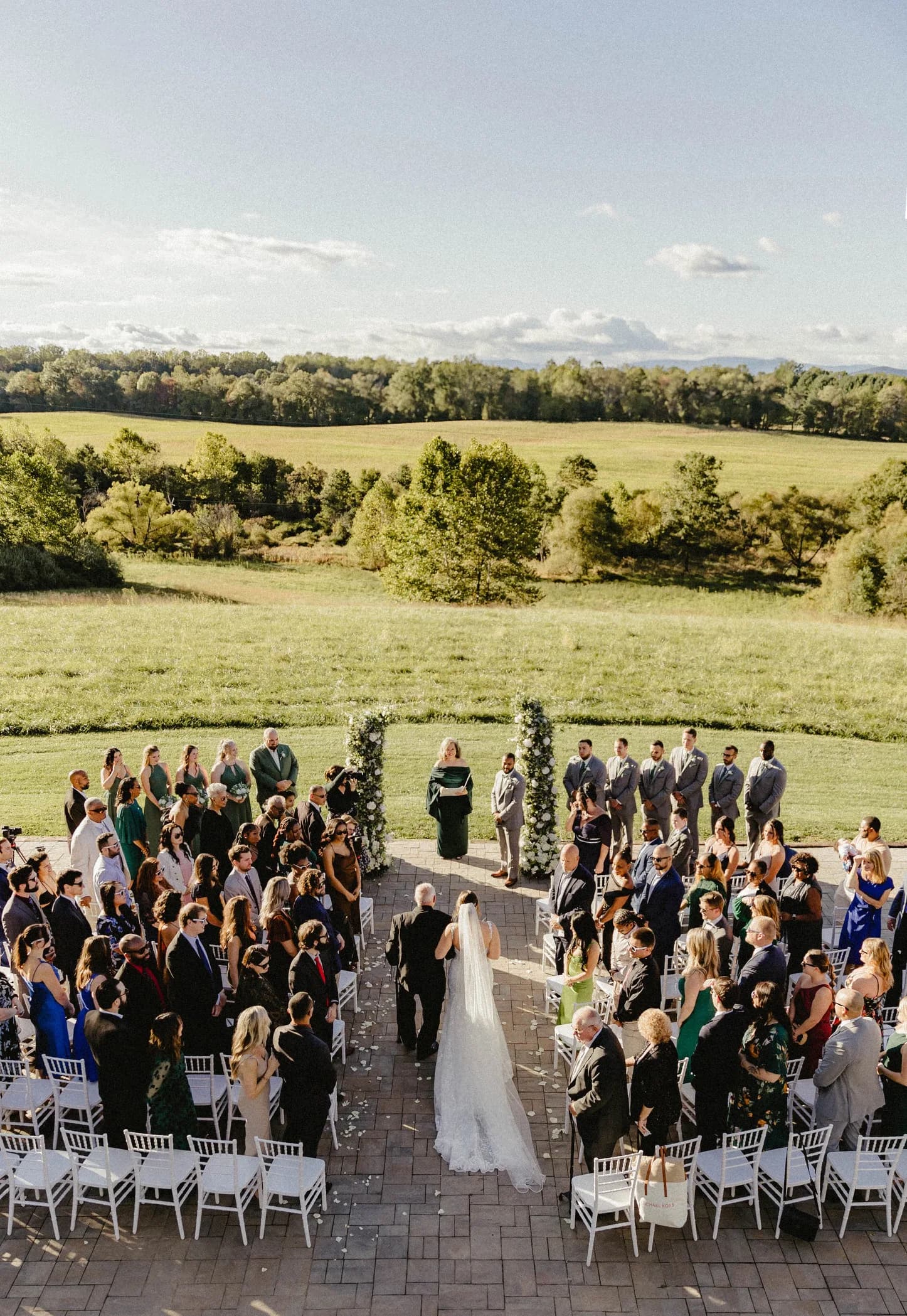 Aerial view of outdoor wedding ceremony at Rixey Manor terrace with rolling Virginia countryside backdrop