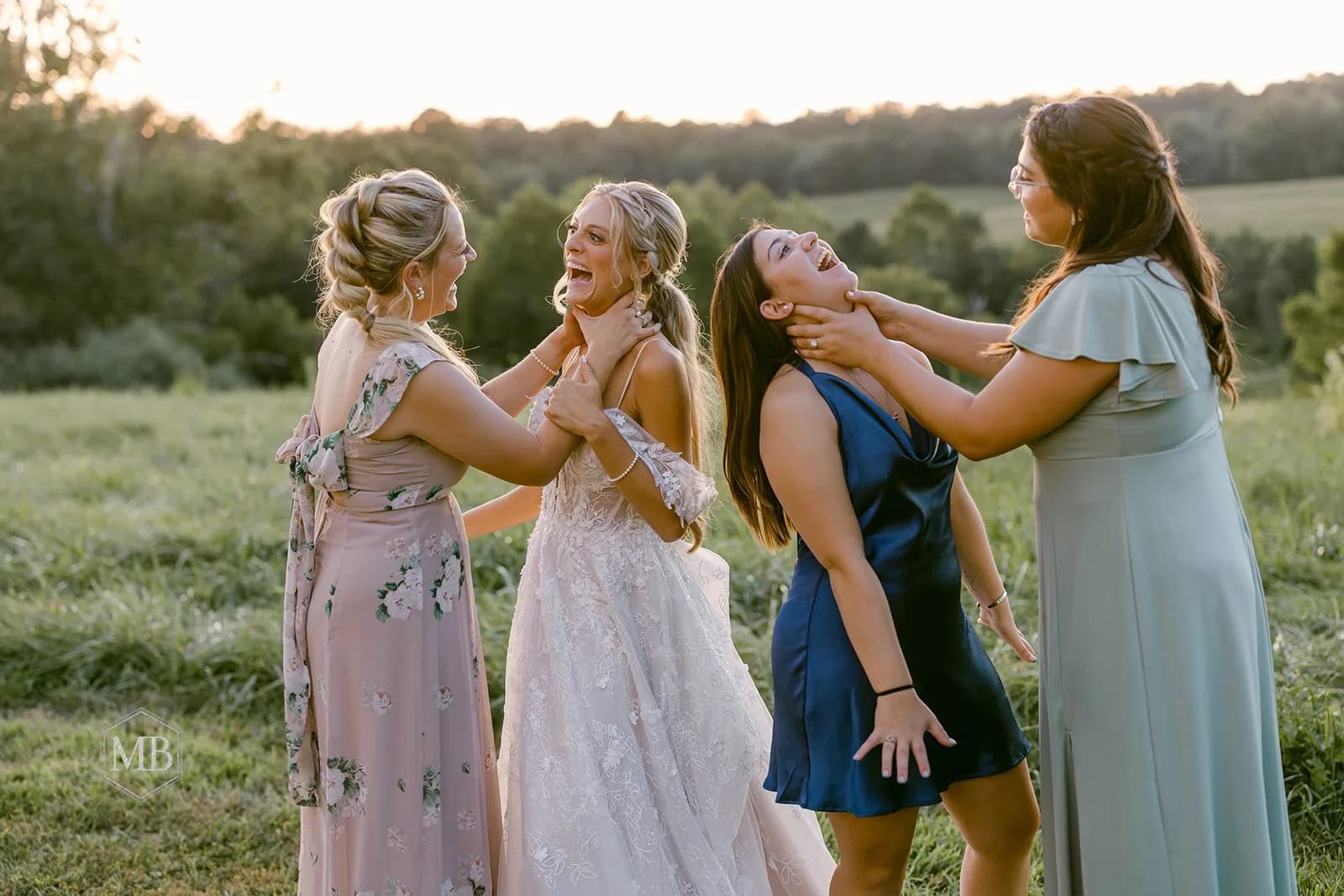 Bride laughing with bridesmaids in golden hour light on green estate grounds