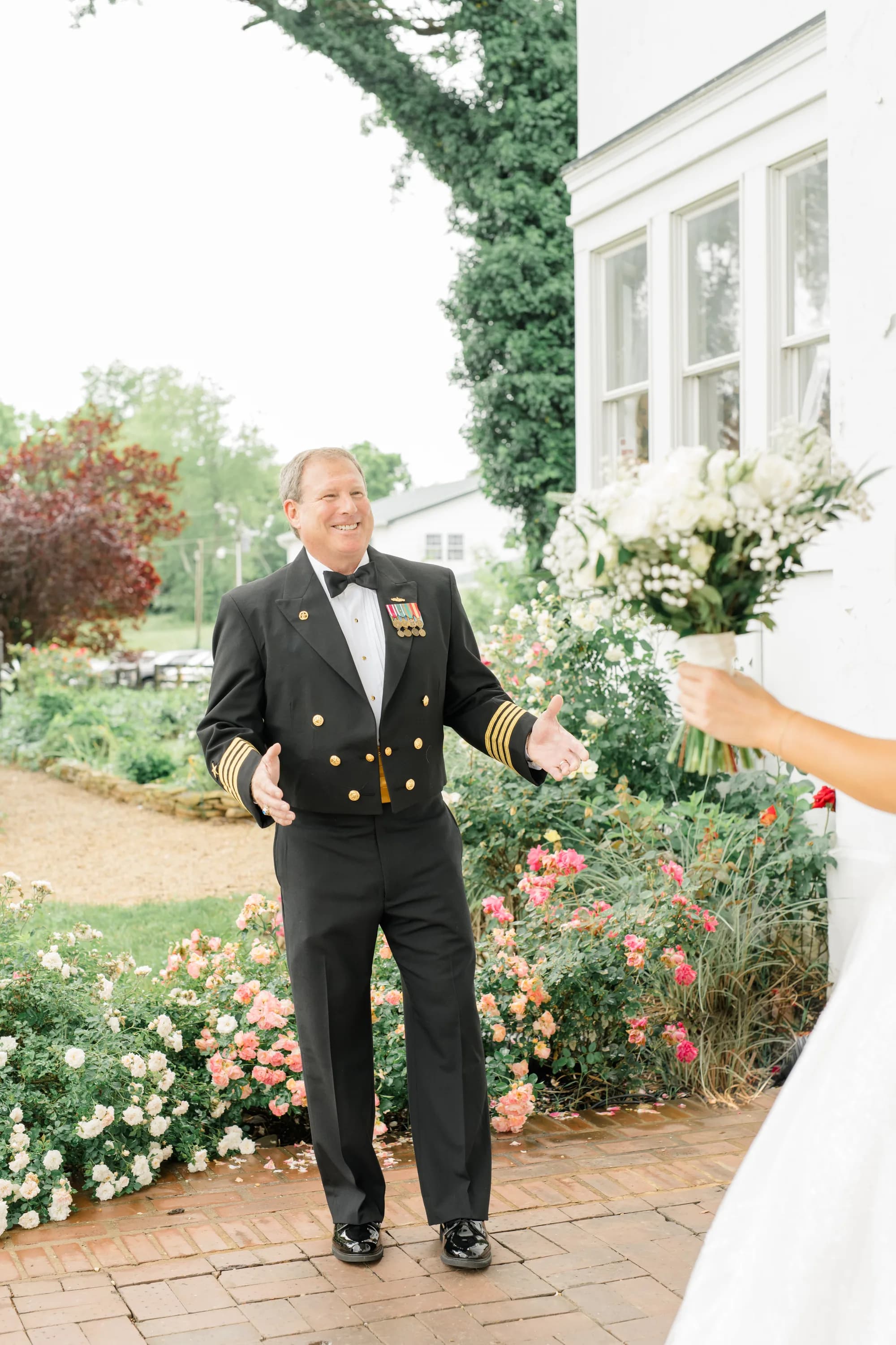 Groom in Navy Military Dress Uniform at Rixey Manor Garden with Ivy-Covered White Building