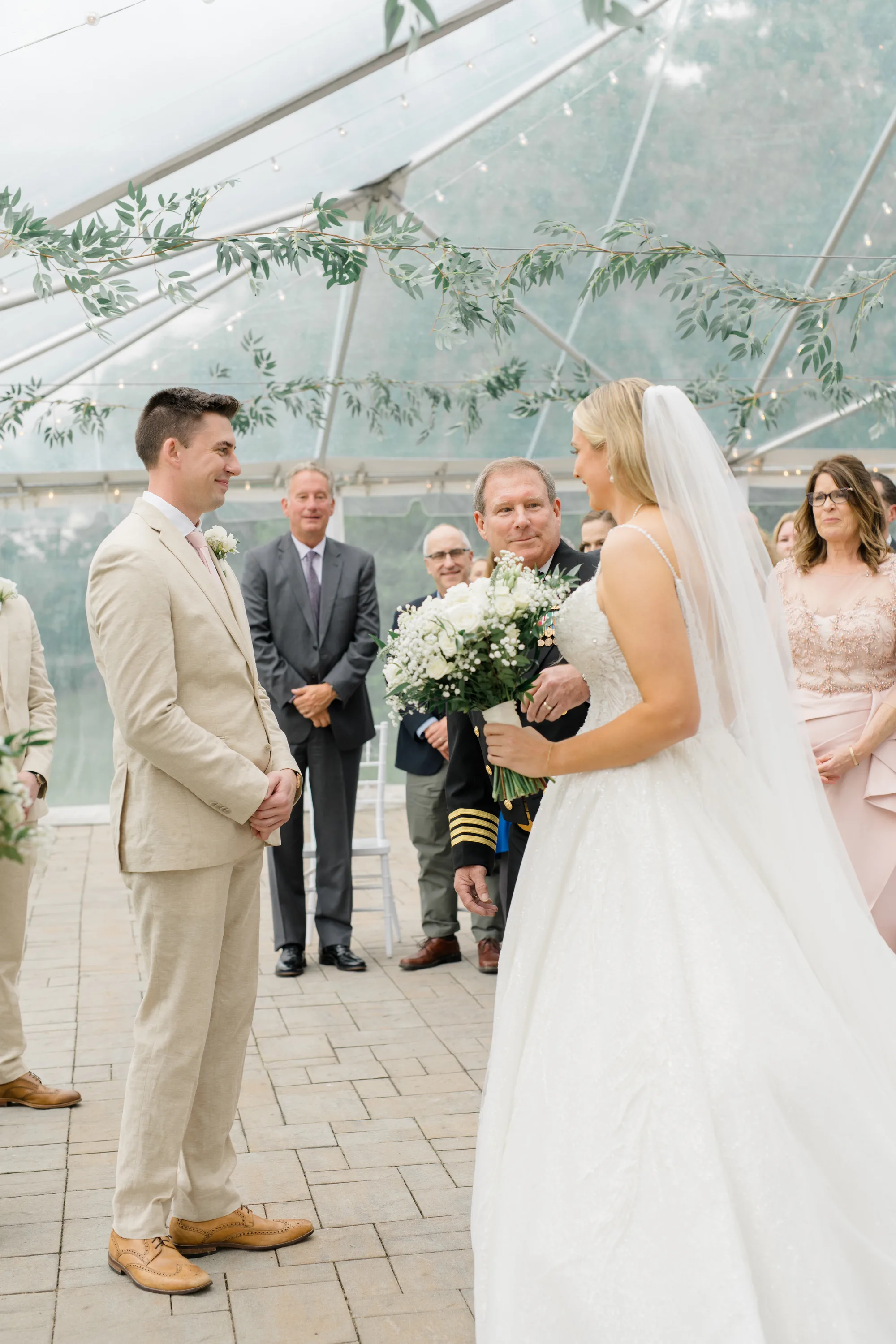 Bride and groom share a tender first look moment under Rixey Manor's elegant clear-top ceremony tent