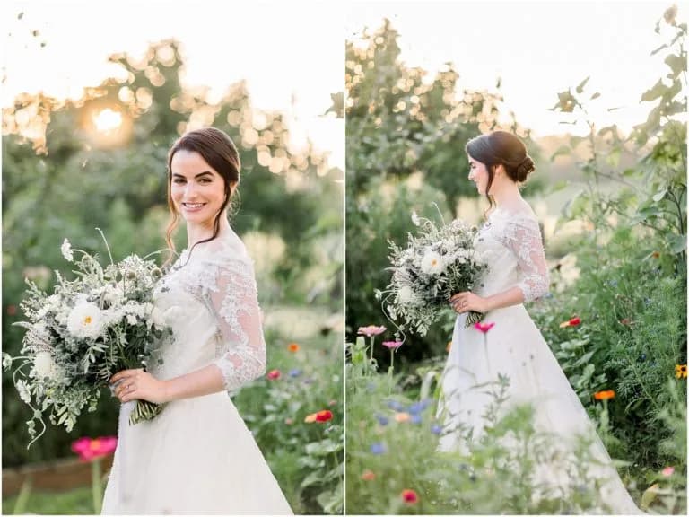 Bride in lace gown holds wildflower bouquet at golden hour in a lush garden, smiling warmly