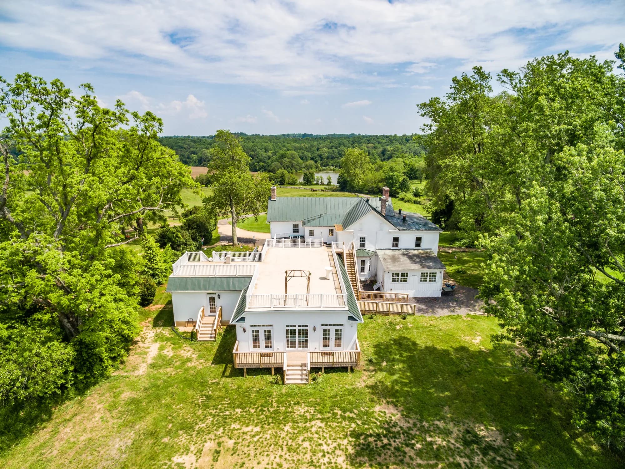 Aerial drone view of Rixey Manor historic estate surrounded by lush Virginia countryside and mature trees