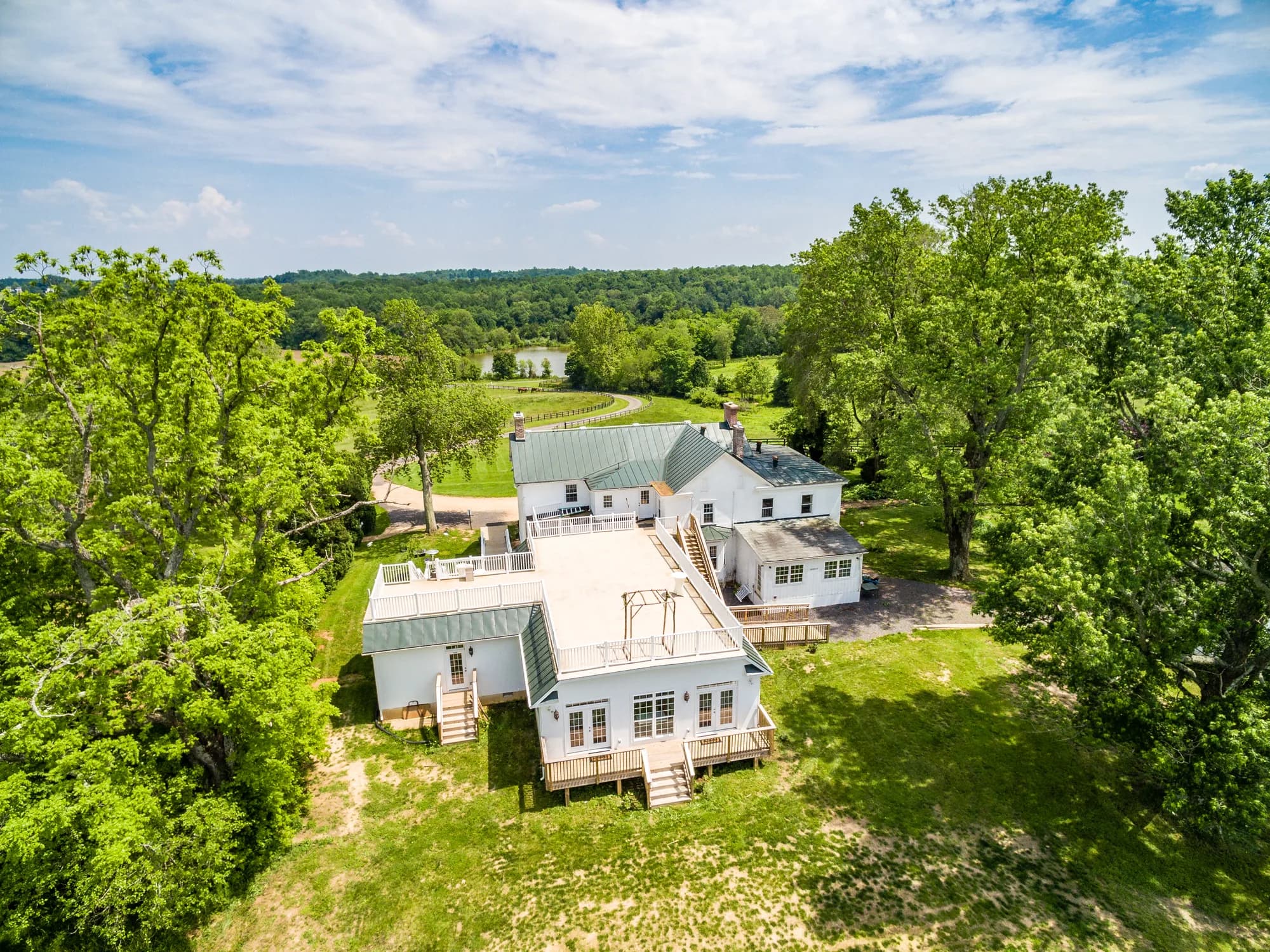 Aerial view of Rixey Manor estate surrounded by lush green trees and rolling Virginia countryside