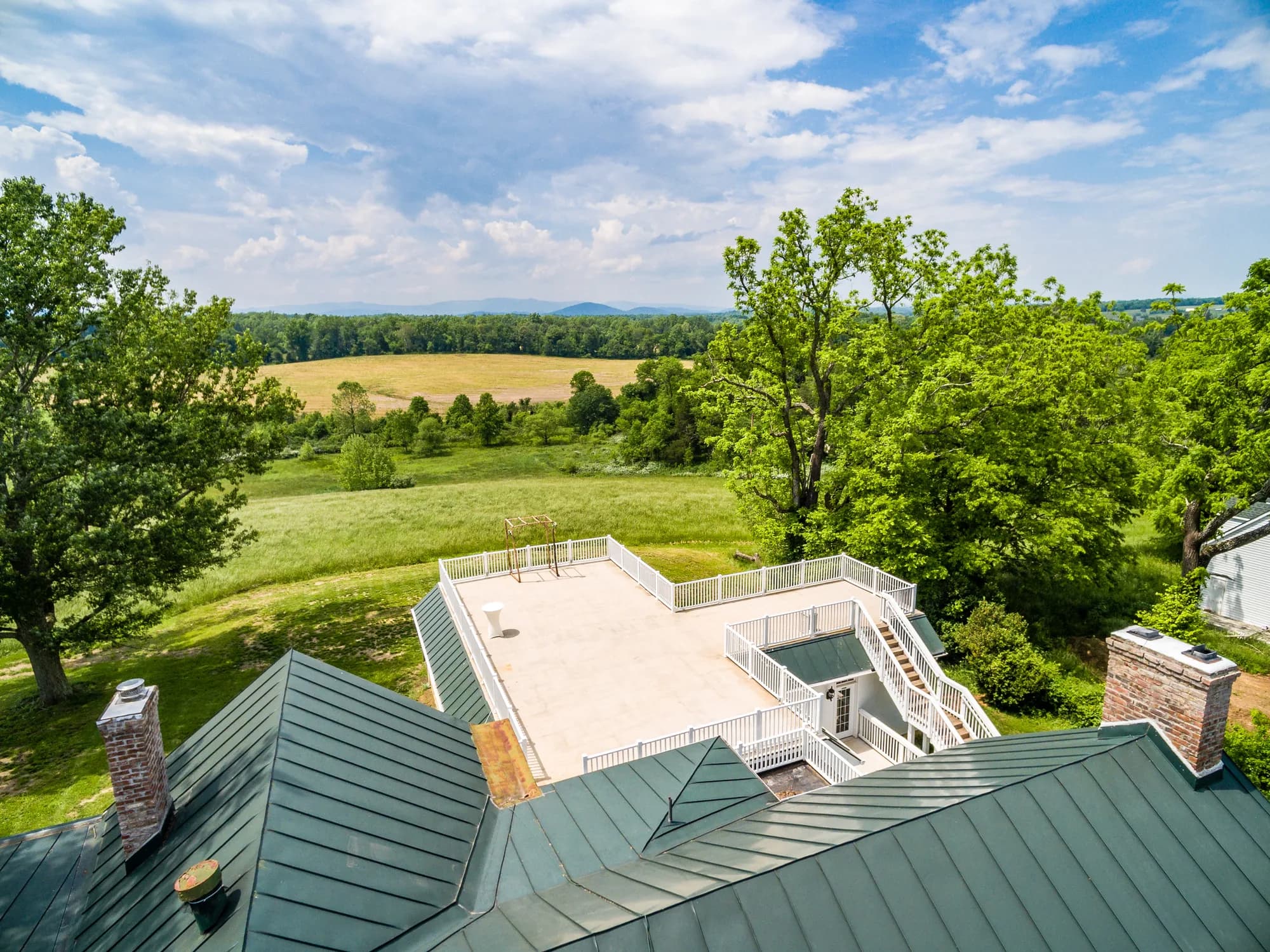 Aerial view of Rixey Manor rooftop terrace overlooking lush Virginia fields and rolling hills