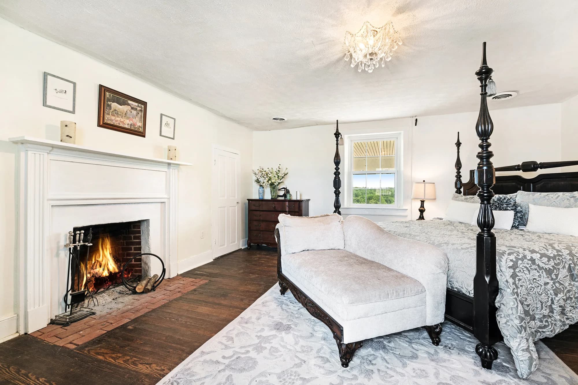 Elegant bedroom with fireplace, four-poster bed, and period furnishings at Rixey Manor